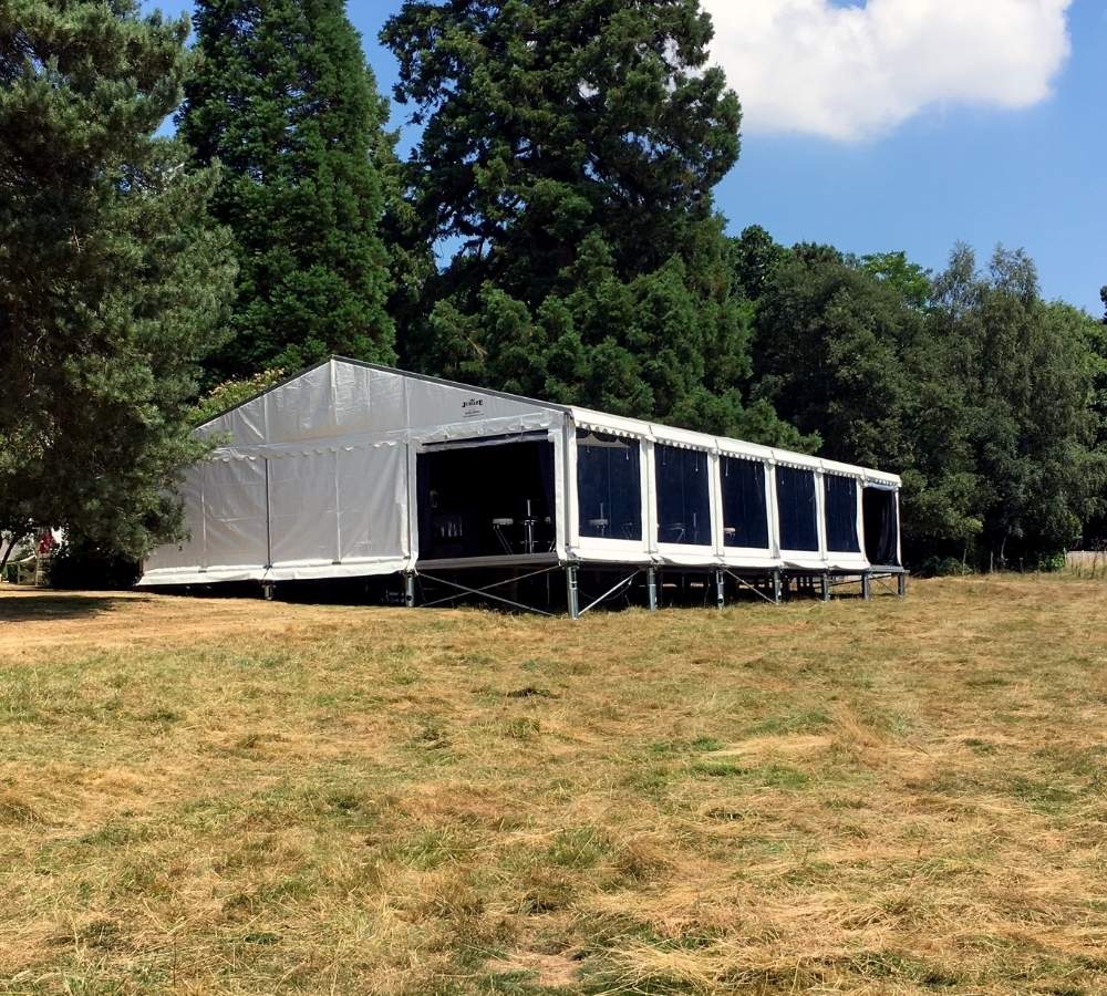 Marquee hard flooring legs. Marquee raised in a field.