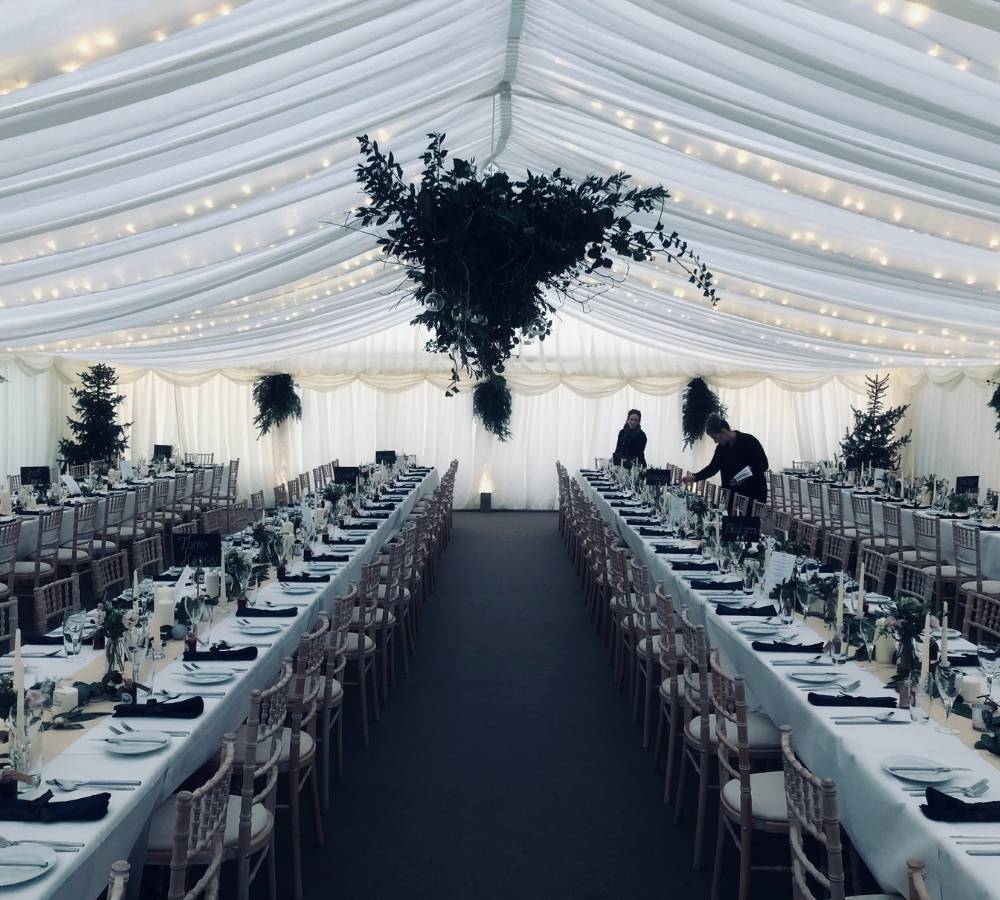 Marquee wedding layout with fairy lights in the lining