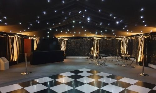 Marquee with starlight lining and uplights on hard flooring in kent